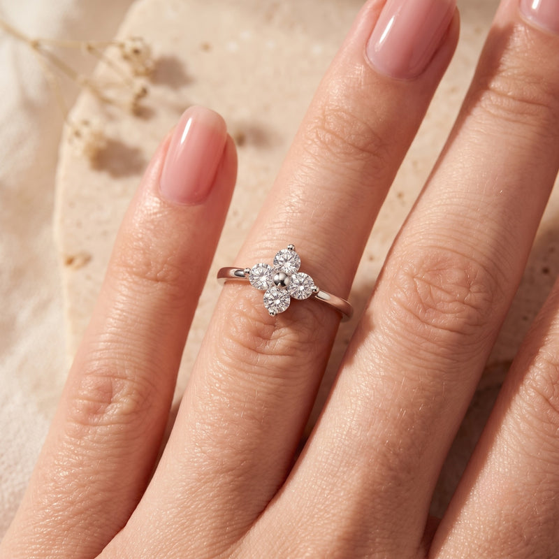 Sterling silver Fleurienne clover ring with round simulated diamonds worn on a woman's finger.