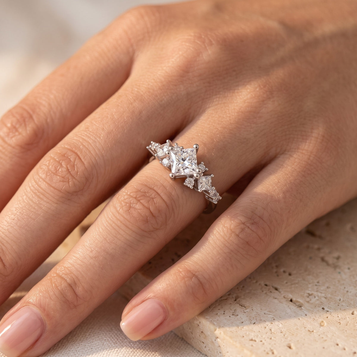 Close-up of the Elestrina silver ring with kite-set princess-cut CZ worn on a finger.