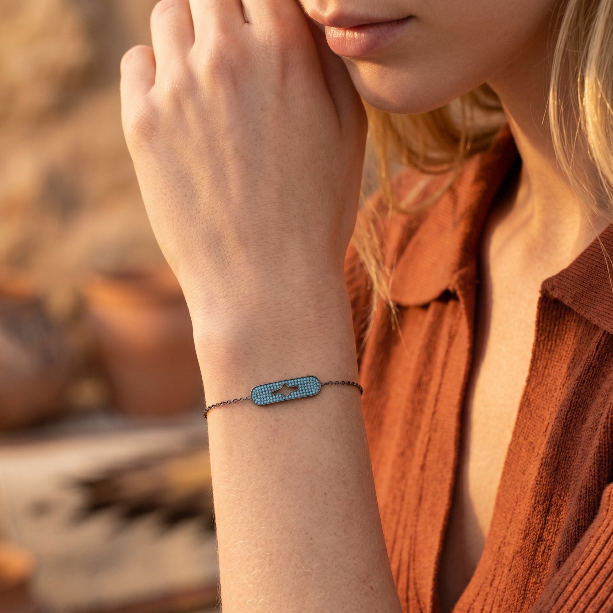 Model wearing the Estrella turquoise and S925 sterling silver bracelet with a central star-shaped cutout station.