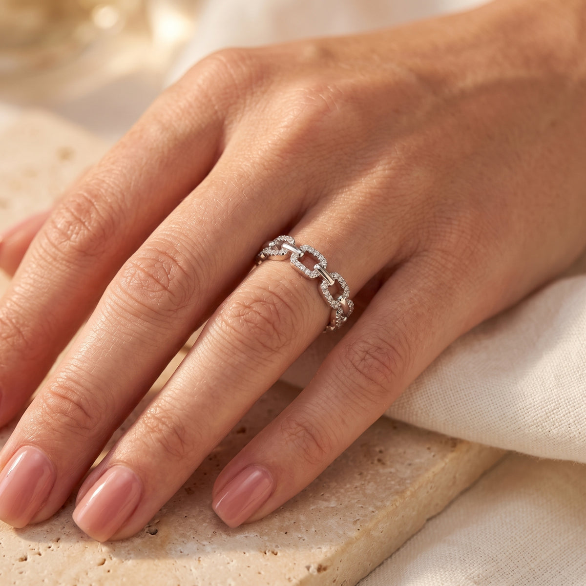 Sterling silver pavé link ring worn on a hand in a lifestyle setting.