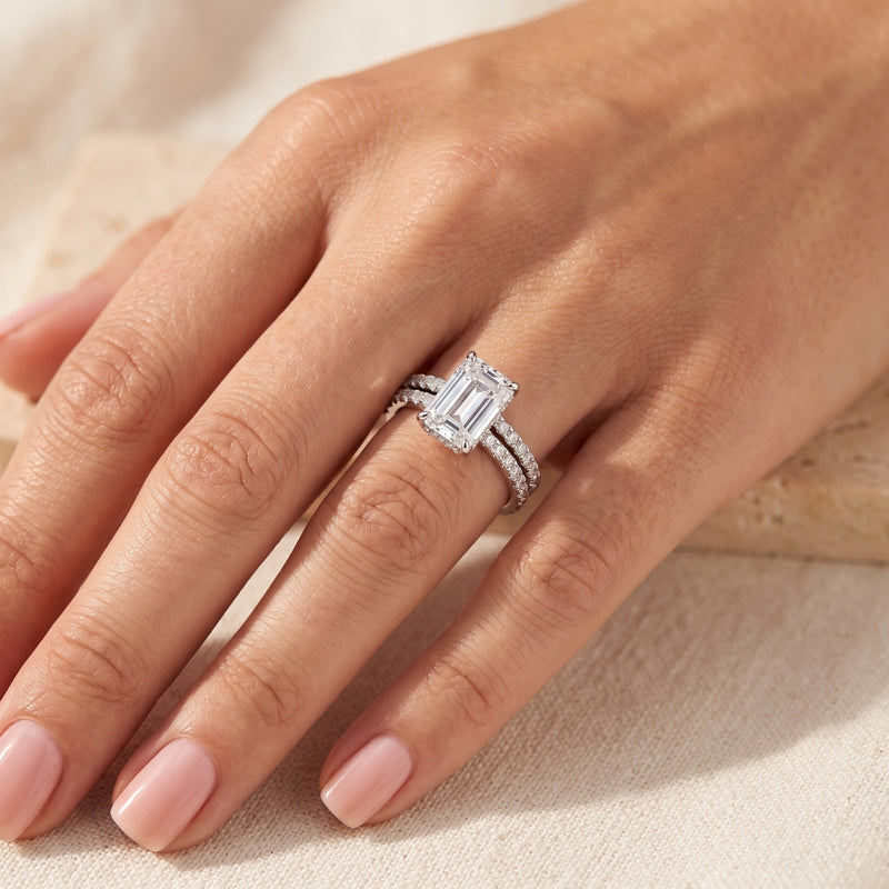 Sterling silver emerald-cut simulated diamond ring set worn on a woman's hand.