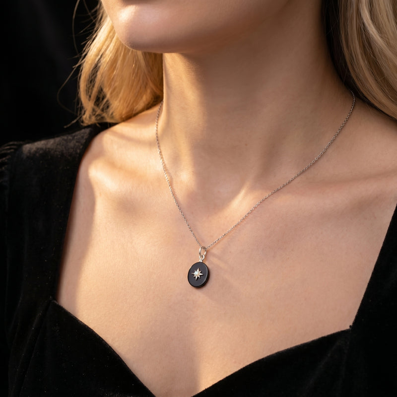 Model wearing the Lydian oval black onyx pendant necklace in silver on a delicate chain.