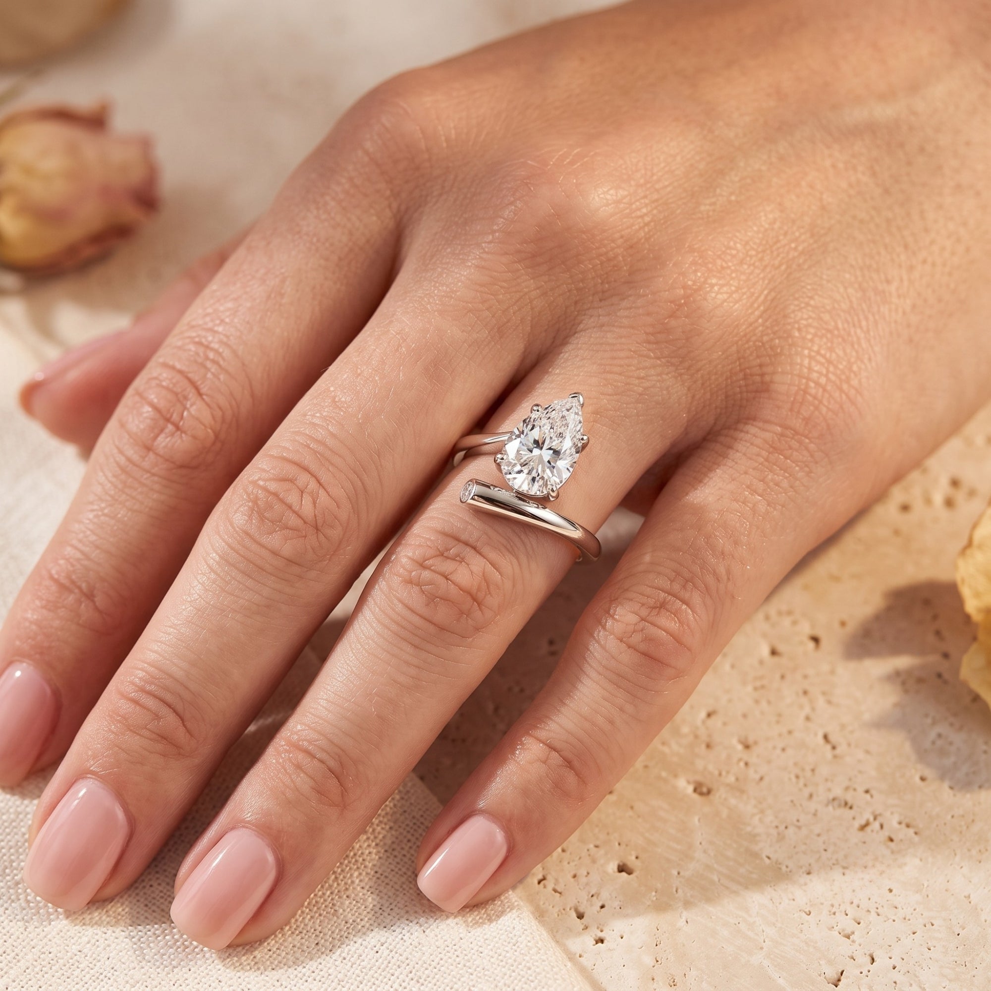 S925 sterling silver pear-cut simulated diamond bypass ring worn on a finger.