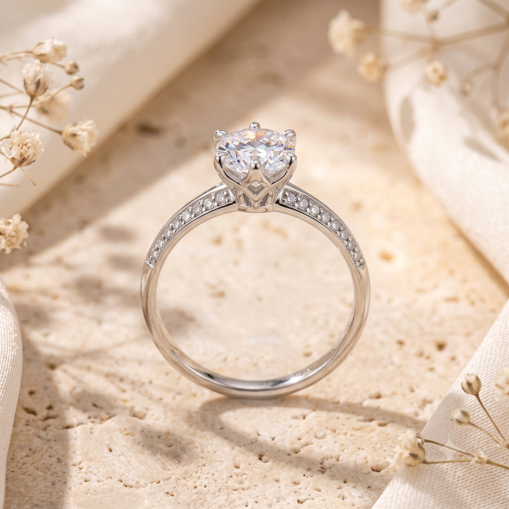 Profile of the Cassidienne silver solitaire ring showing the round stone and pavé setting.