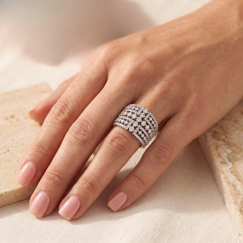 Wide sterling silver multi-row simulated diamond ring worn on a woman's hand.