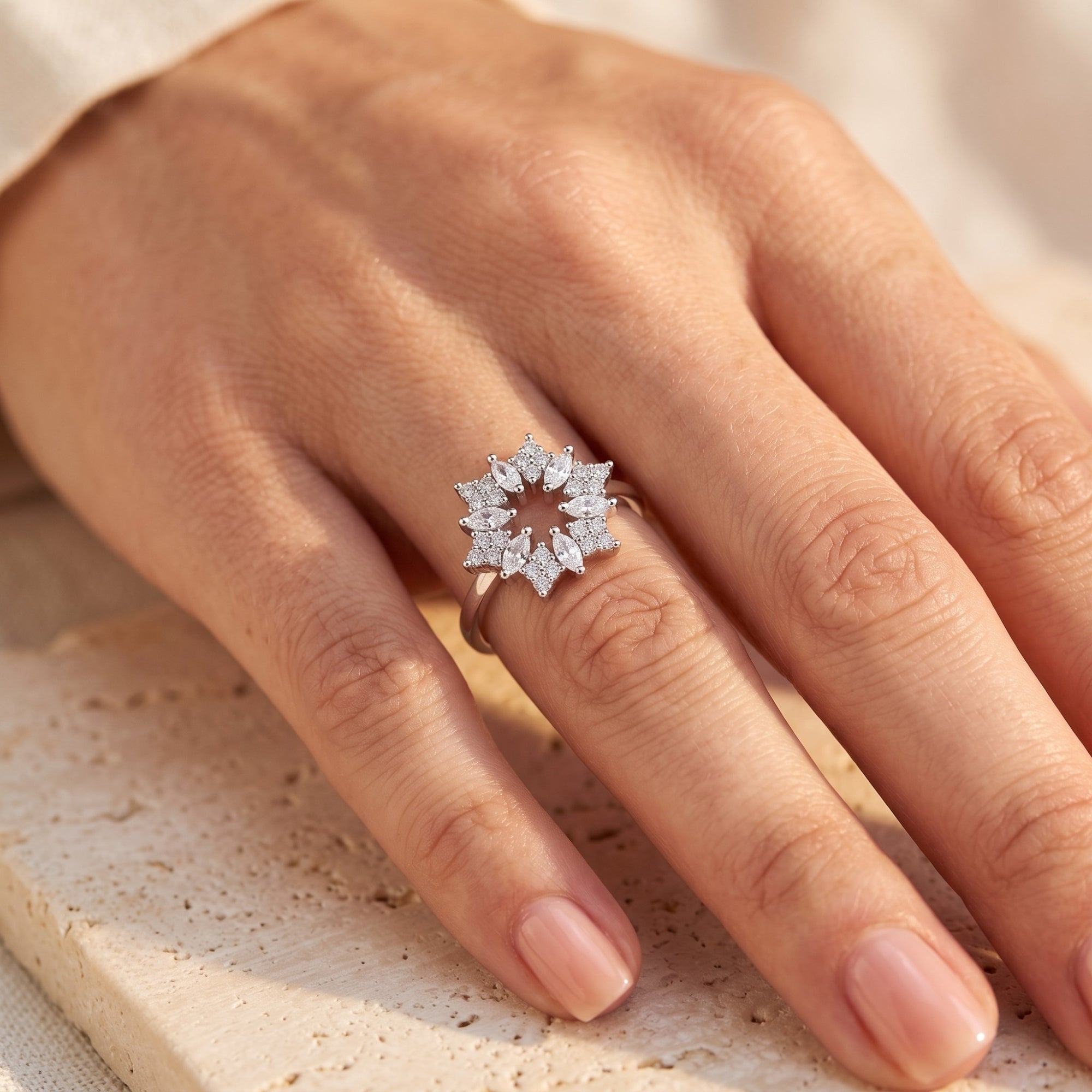 Stellaire S925 sterling silver starburst promise ring with marquise stones worn on a woman's hand.