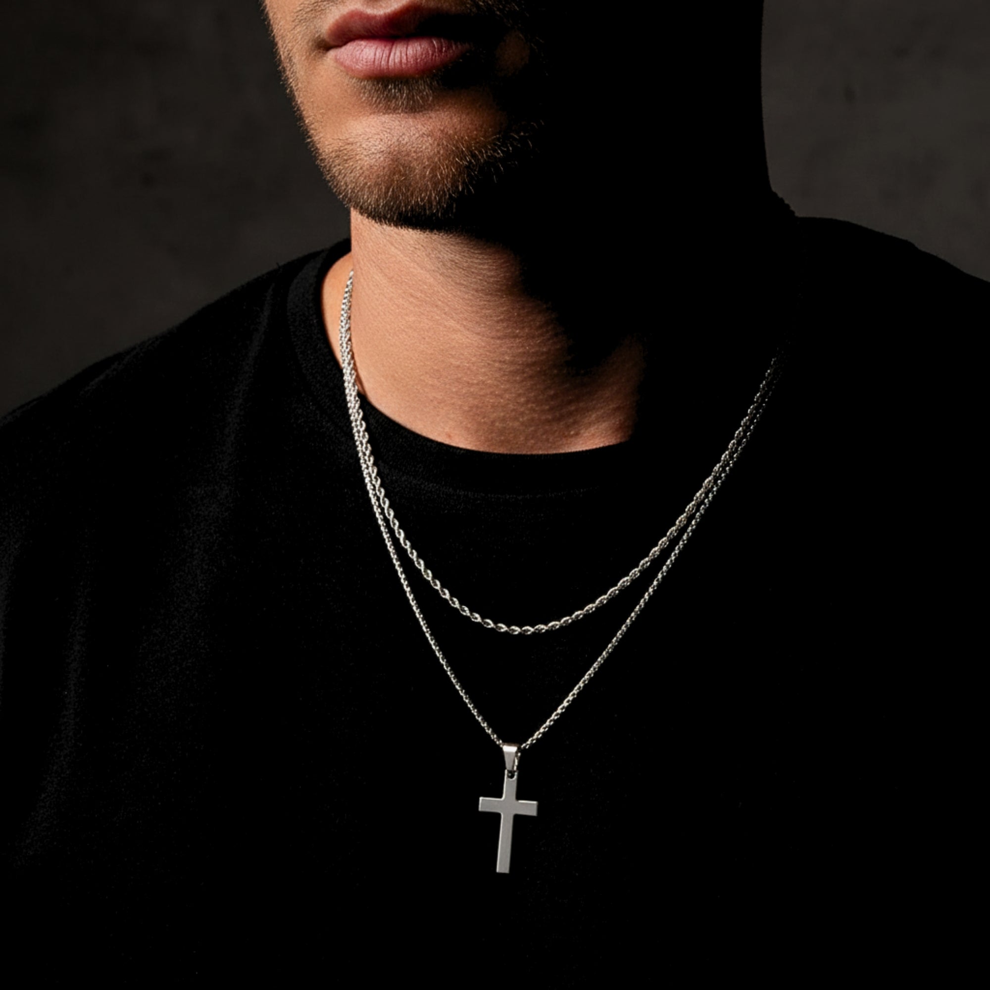 Layered look featuring the silver stainless steel Apostle Cross pendant and a rope chain on a male model.