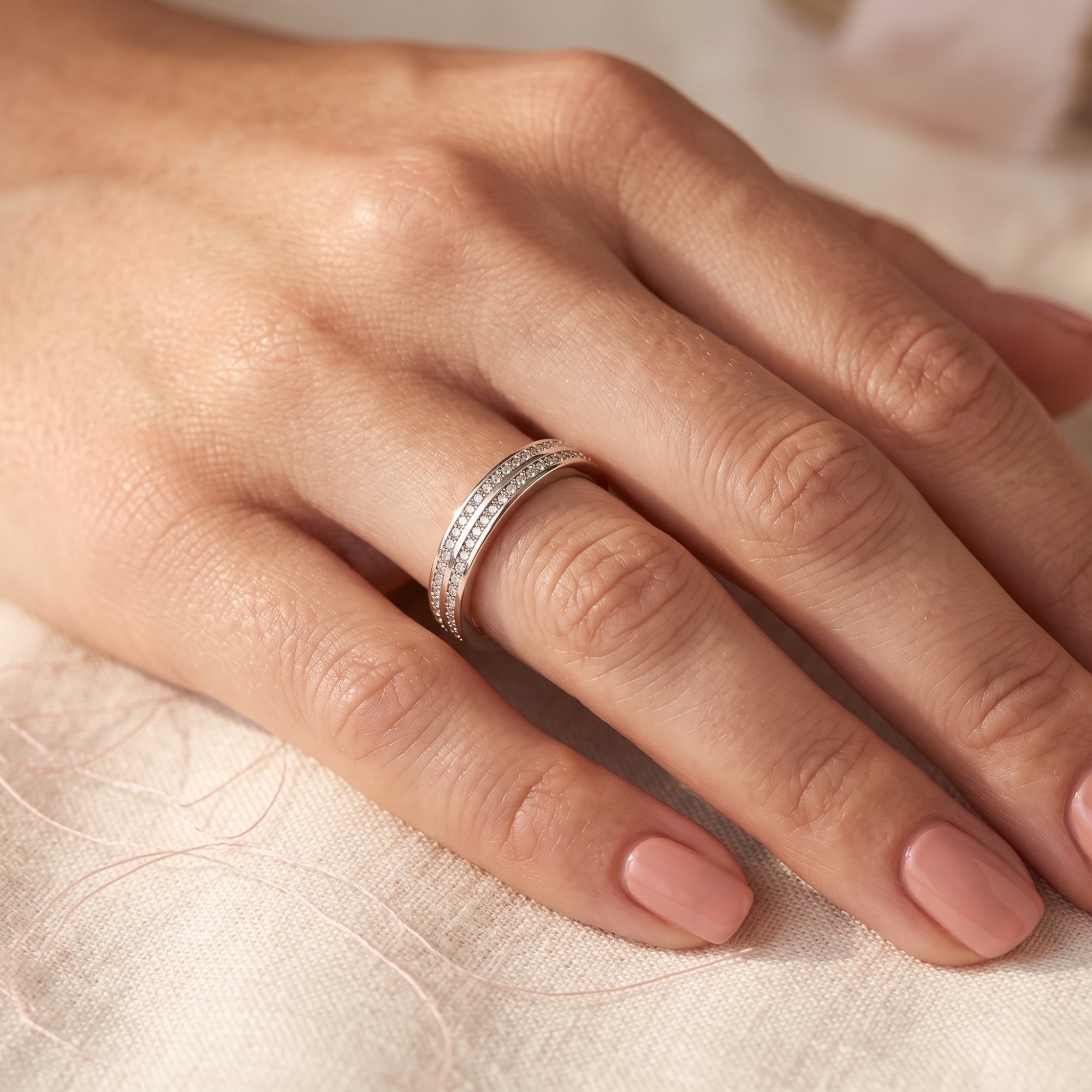 The Margaux double-row pavé sterling silver ring with simulated diamonds worn on a woman's ring finger.