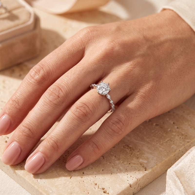 Round-cut simulated diamond sterling silver ring worn on a woman's hand.