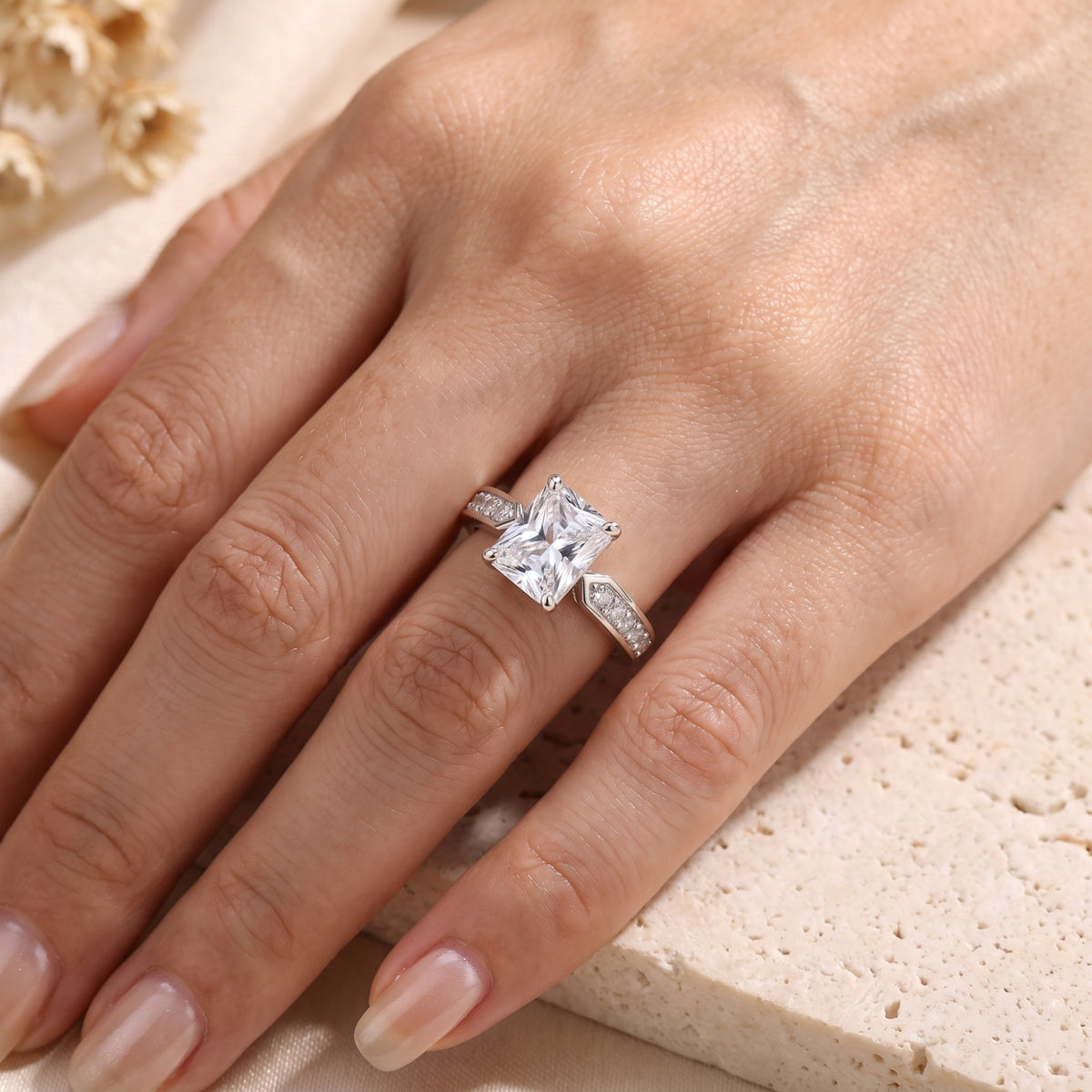 Radiant-cut simulated diamond sterling silver ring worn on a woman's hand.