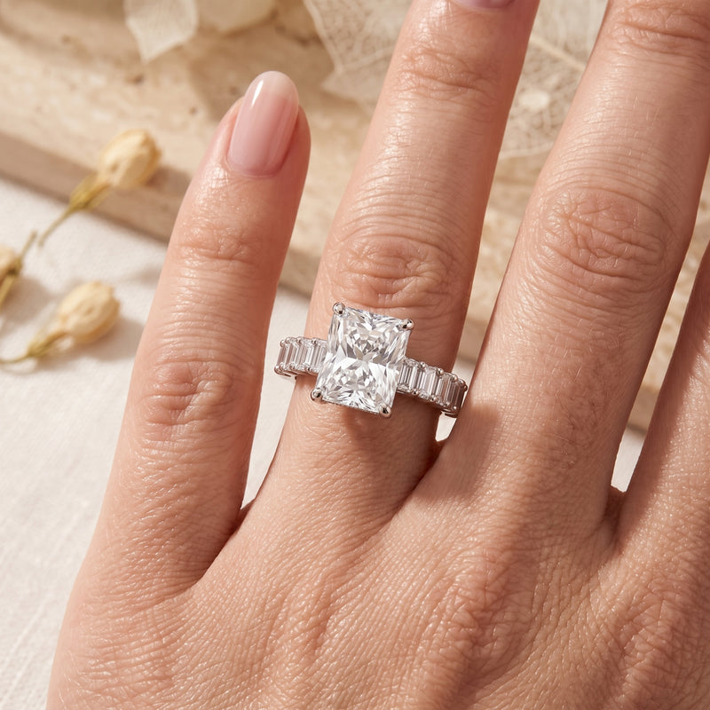 Top view of the sterling silver radiant cut simulated diamond ring worn on a woman's hand.