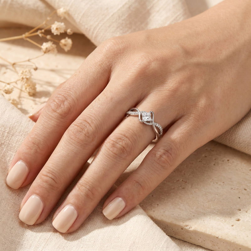 S925 sterling silver princess cut moissanite promise ring worn on a model's hand.