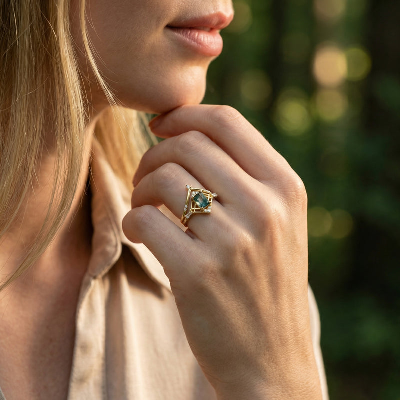 Model wearing the gold-plated moss agate geometric ring set on her finger in a natural outdoor setting.