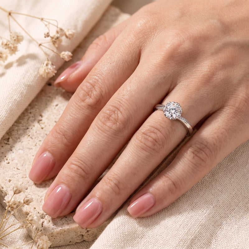 Sterling silver round cut simulated diamond ring worn on a woman's hand.
