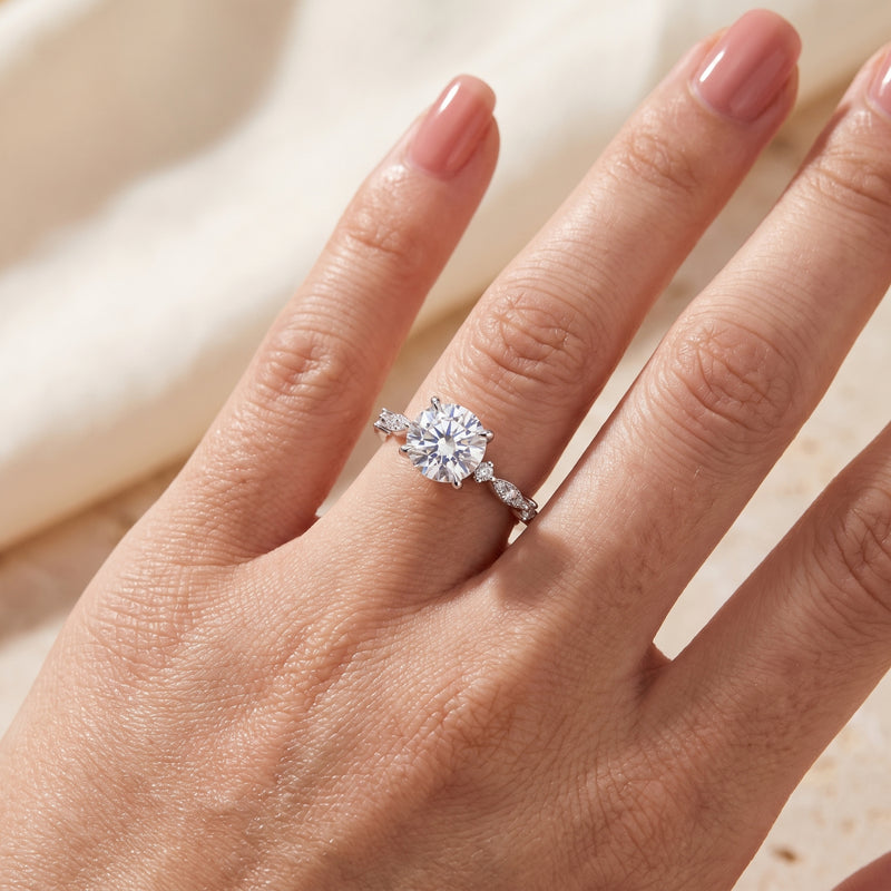 Sterling silver round-cut simulated diamond promise ring worn on a woman's hand.