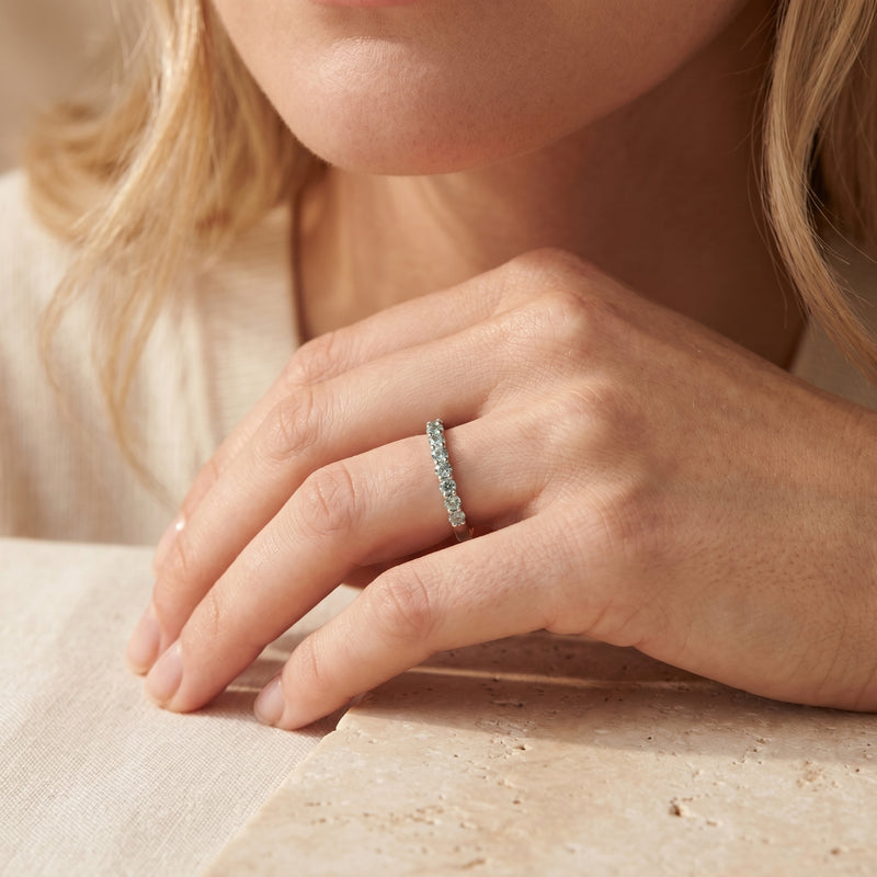 Fiorina sterling silver ring with round simulated alexandrite stones worn on a model's finger.