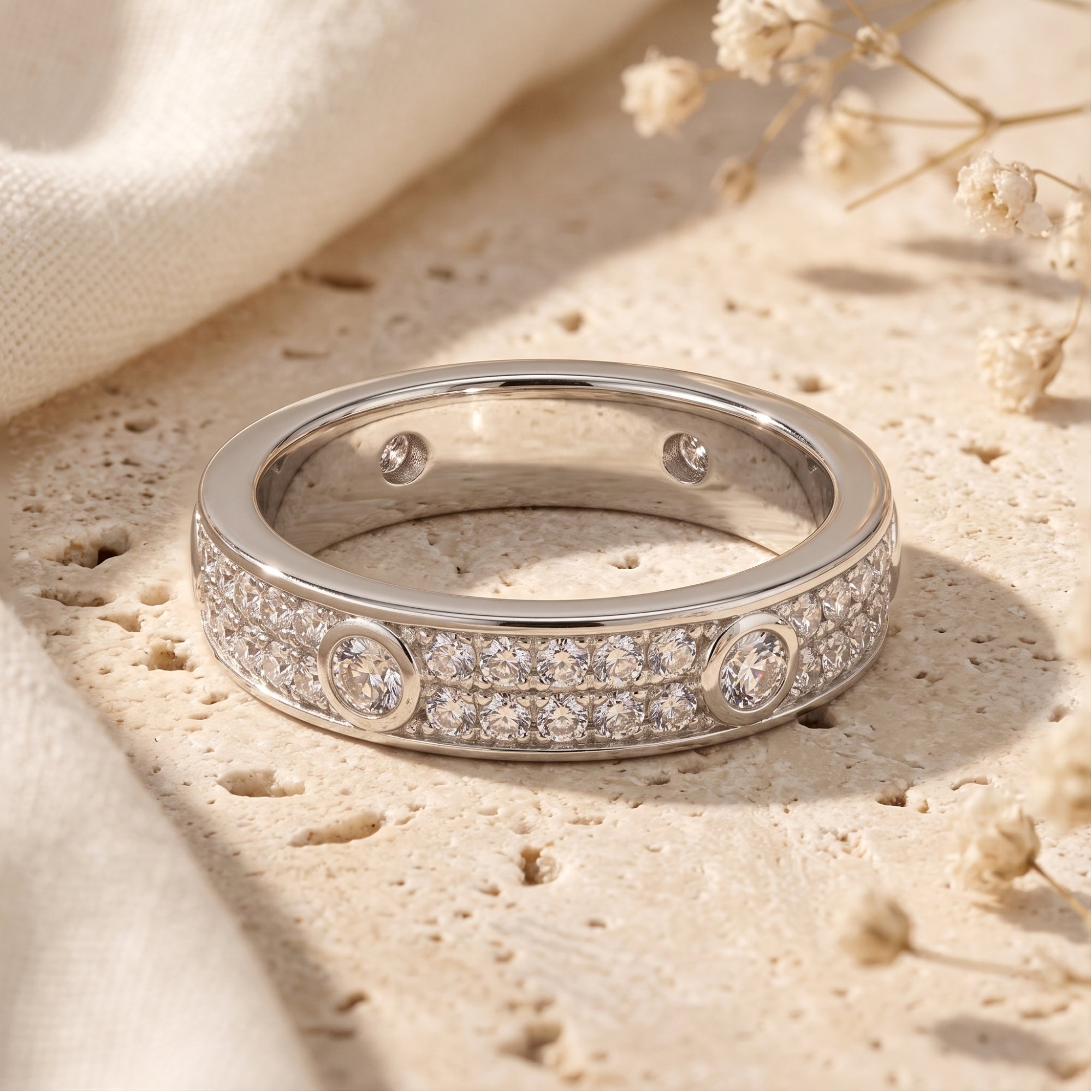 Macro view of a sterling silver band featuring double rows of round-cut pavé CZ stones.