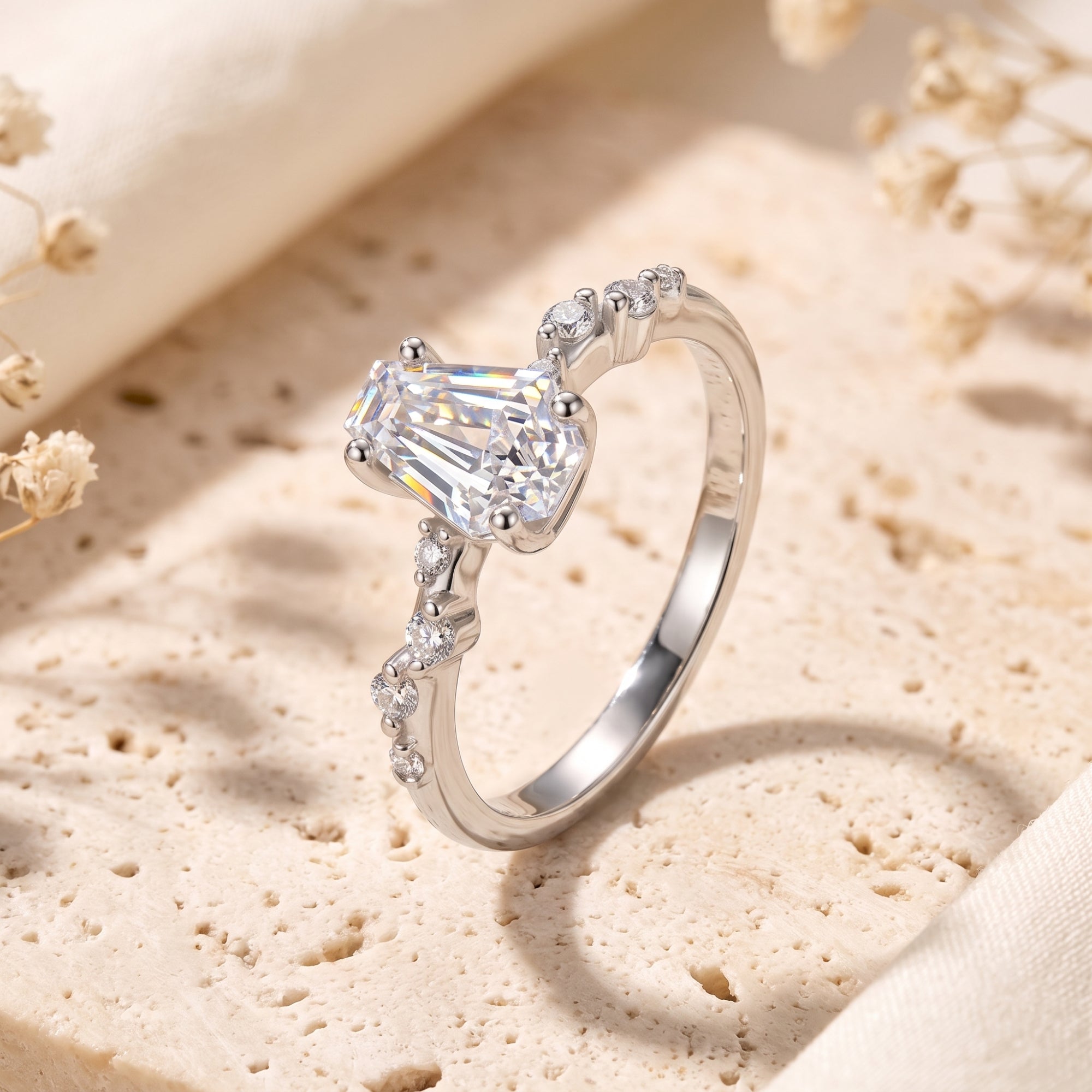 Side view of the silver Rosmerta ring showing the coffin-cut simulated diamond and accent stones on a stone base.