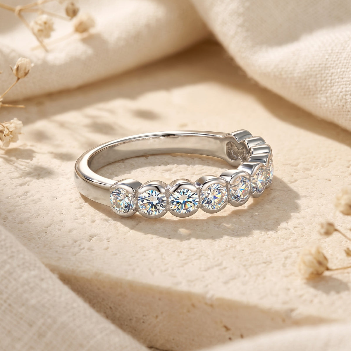 Close-up of the round-cut simulated diamond bezel settings on the S925 sterling silver Zarielle eternity band.