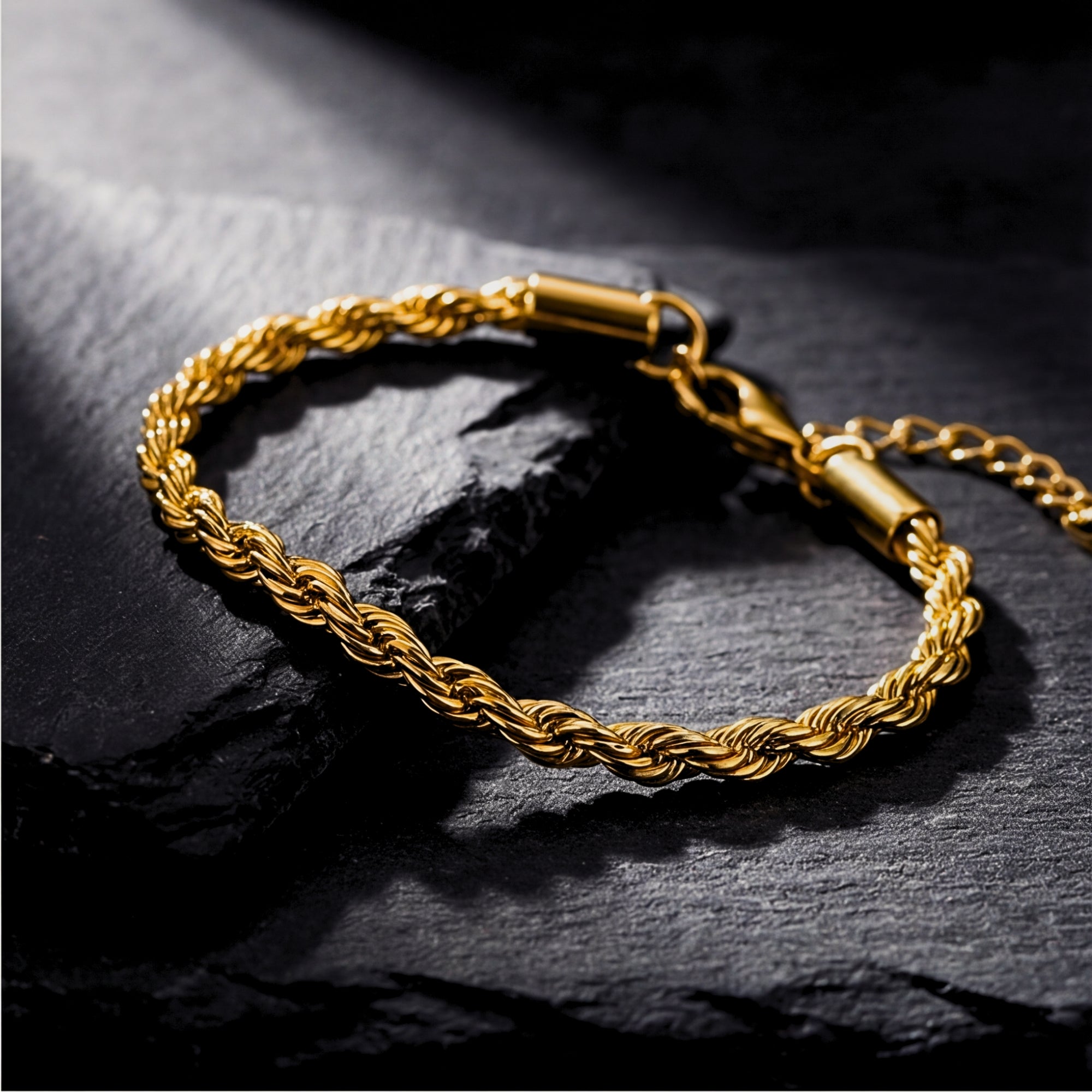 Detailed close-up of the 5mm twisted links on a gold stainless steel rope bracelet for men.