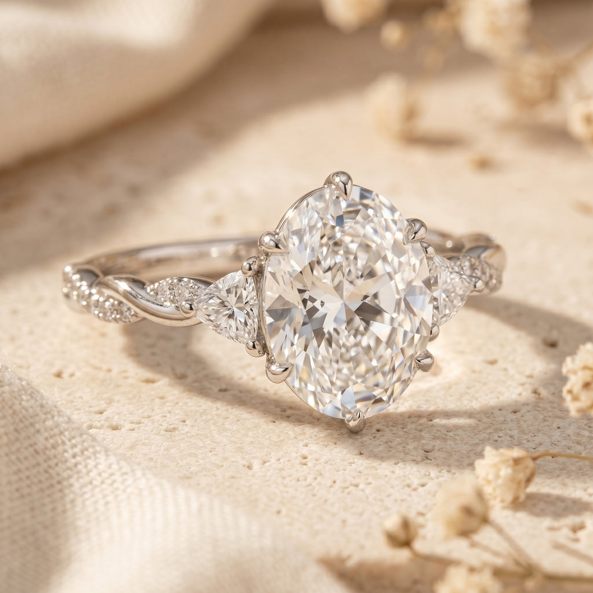 Macro view of an oval moissanite ring featuring a twisted band in solid gold.