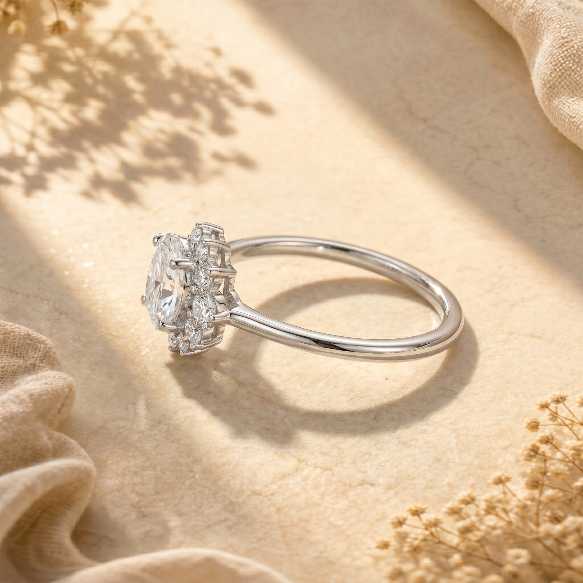 Side profile of the sterling silver Elysinara ring highlighting the 2CT oval moissanite and cluster setting.