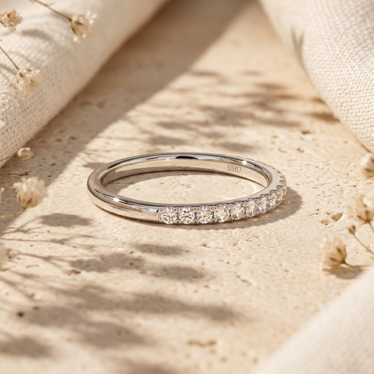 Close-up of the Sylvienne moissanite ring showing the S925 sterling silver hallmark and shimmering pave stones.