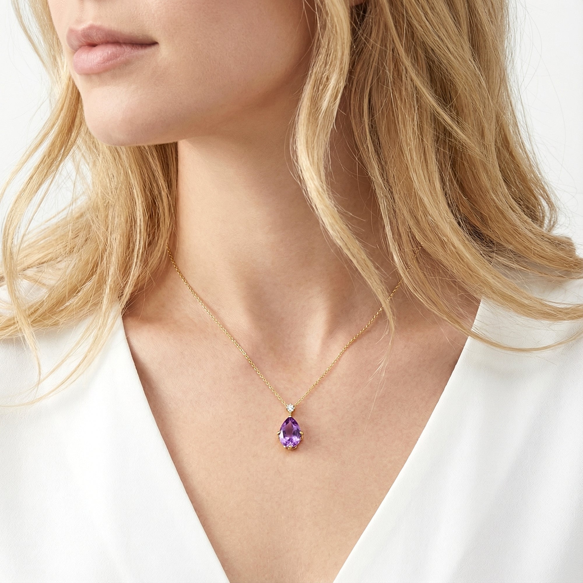 Woman wearing the pear-cut simulated amethyst teardrop necklace in 18K gold vermeil.