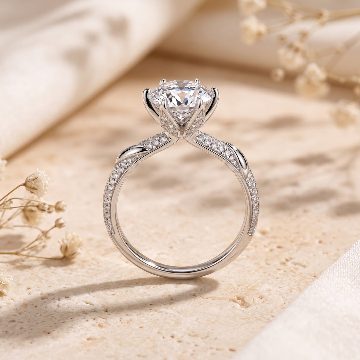 Side view of silver Neridelle ring showing round stone and pavé twist band detail.