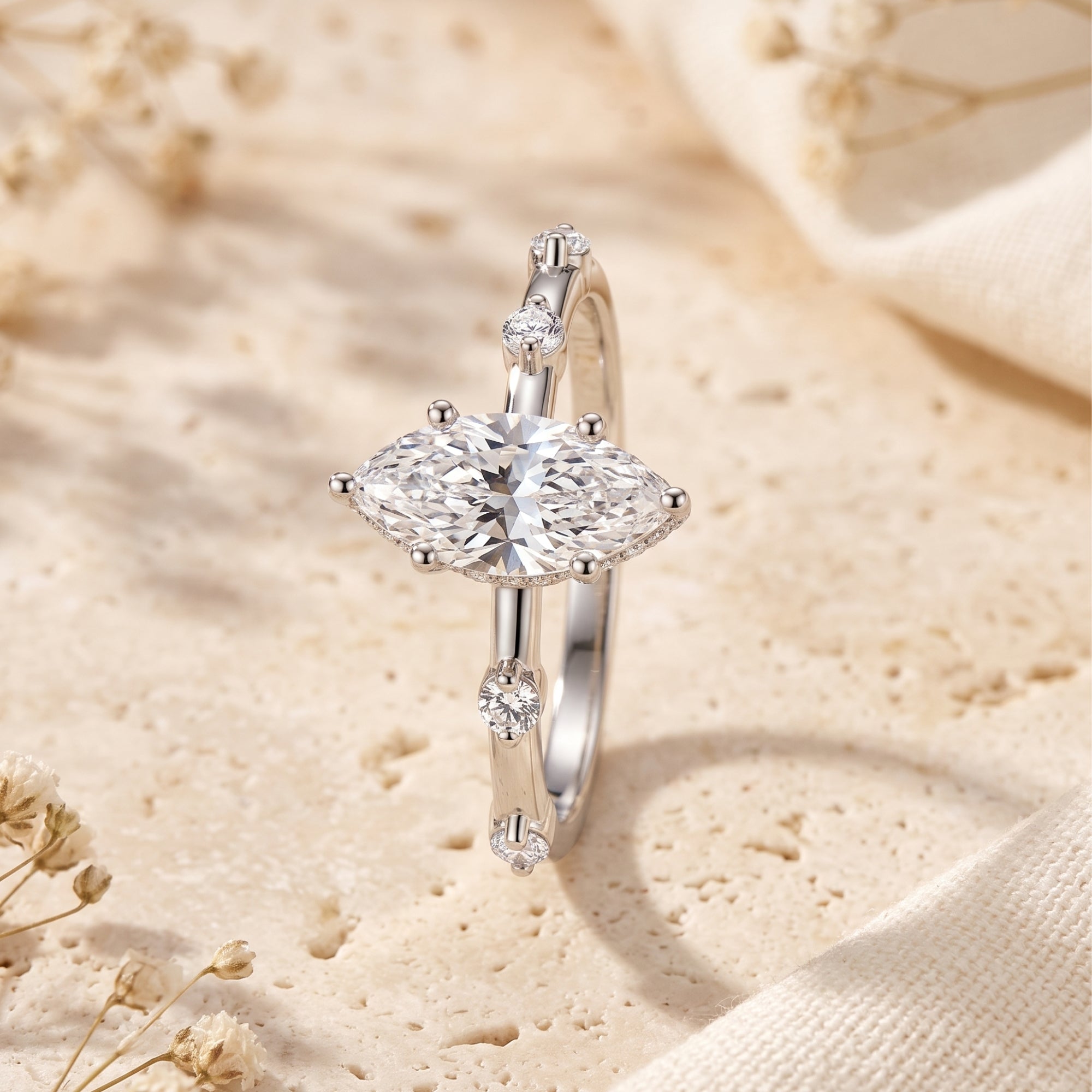Macro view of the 5x10mm marquise cut simulated diamond and accent stones on the Isabetta sterling silver ring.