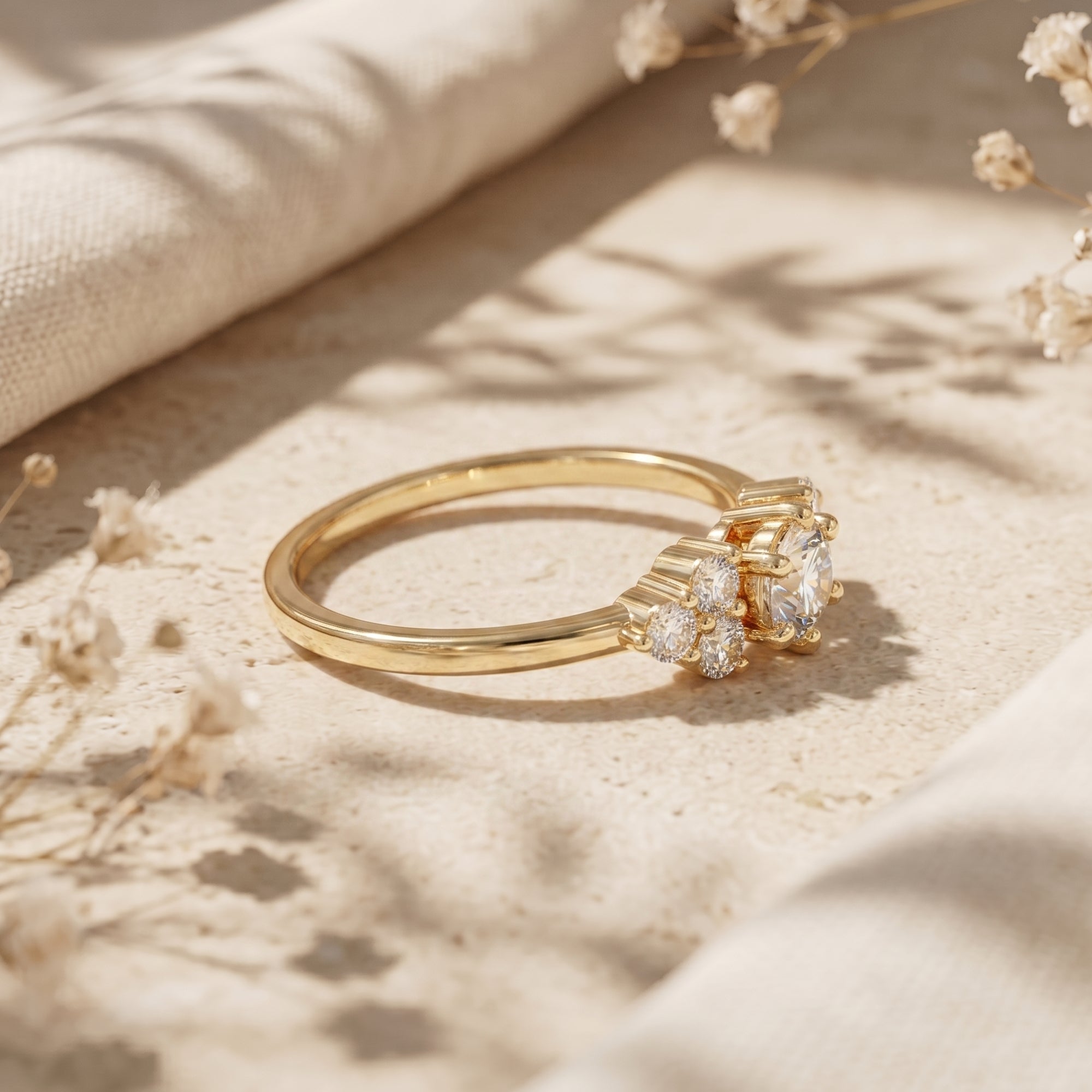 Side view of the yellow gold Aurestria ring featuring a 1CT round moissanite and cluster setting on stone.