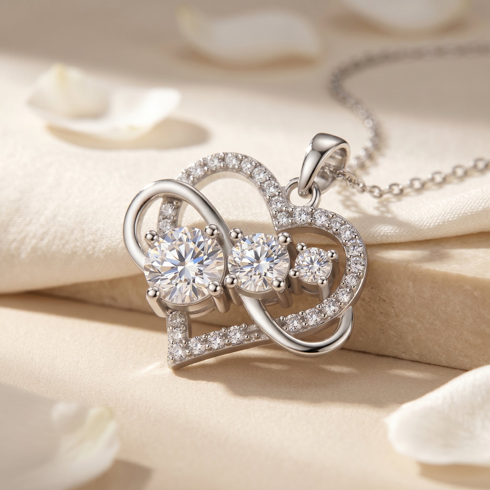 Macro view of the Aureliette moissanite heart infinity pendant necklace with three round-cut moissanite stones.