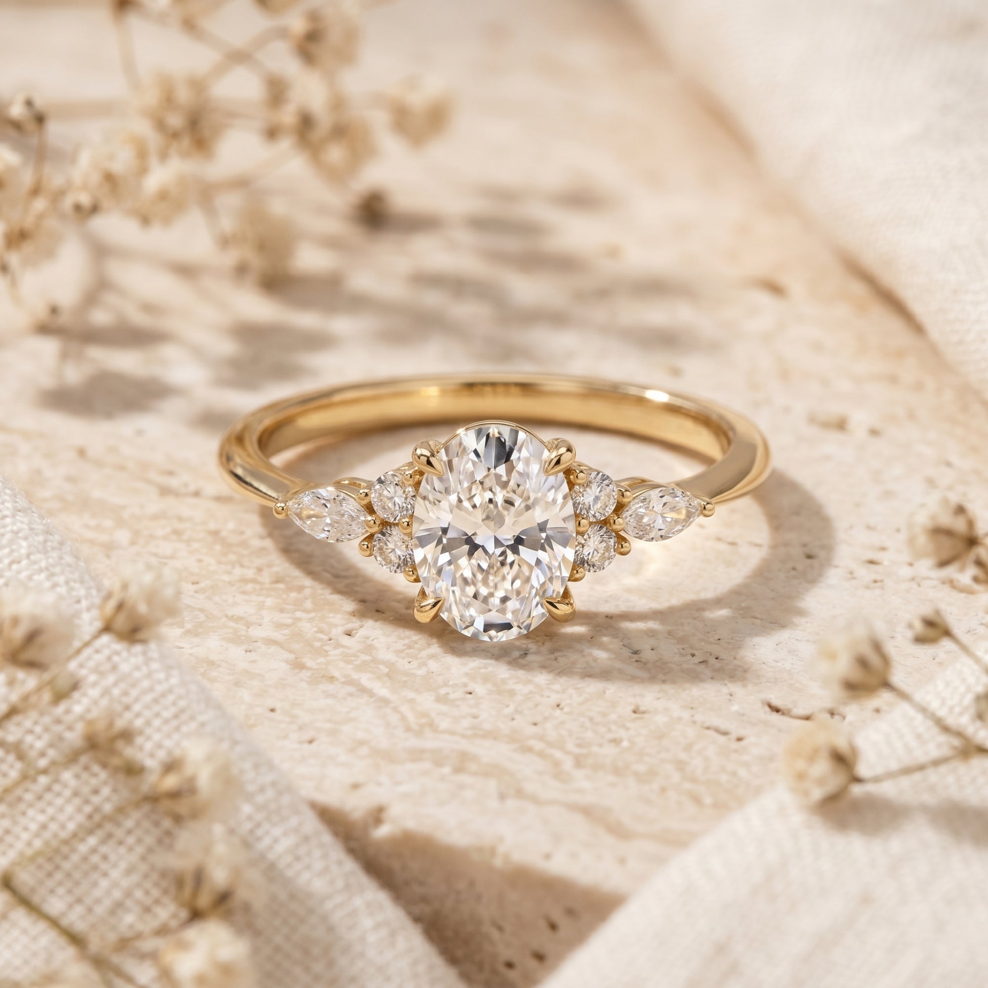 Gold oval moissanite promise ring displayed on a rustic stone background.
