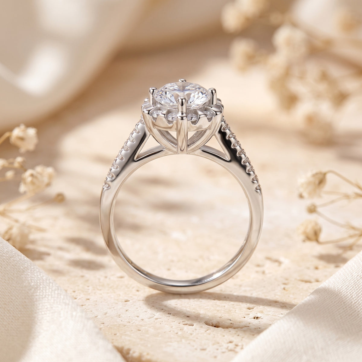 Side profile of the silver halo ring showing its elevated basket setting, gallery, and pavé band.