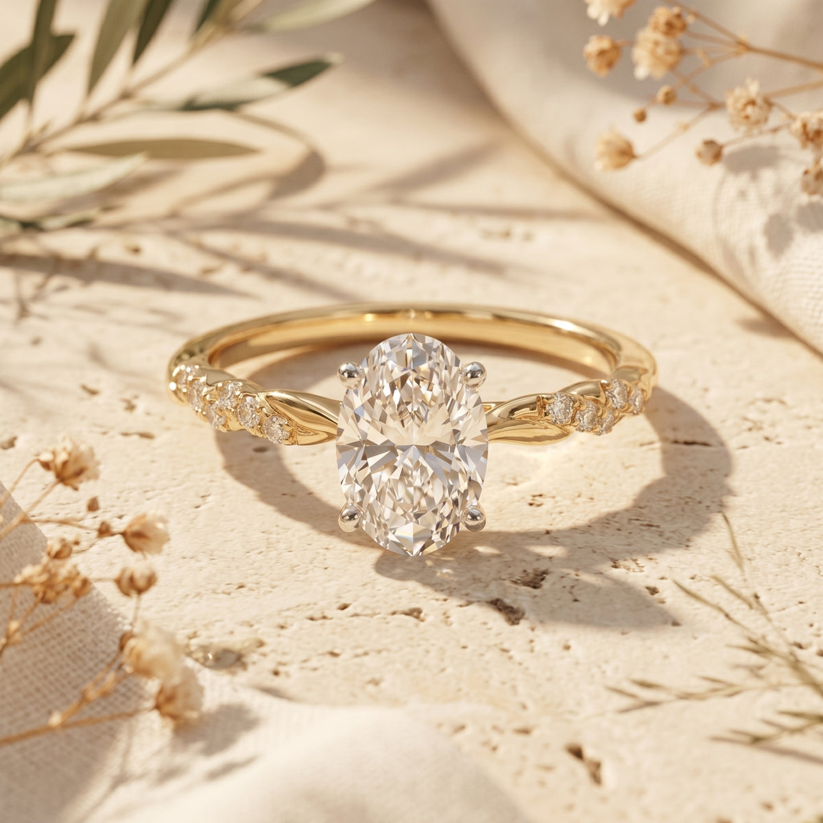 Yellow gold oval moissanite ring on stone surface.