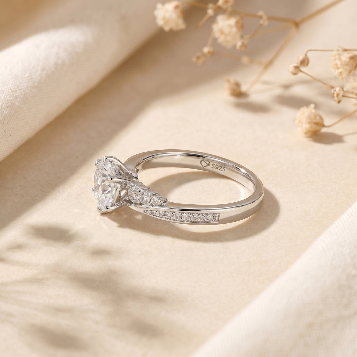 Side profile of the Nicolette sterling silver ring showing the six-prong setting and S925 hallmark.