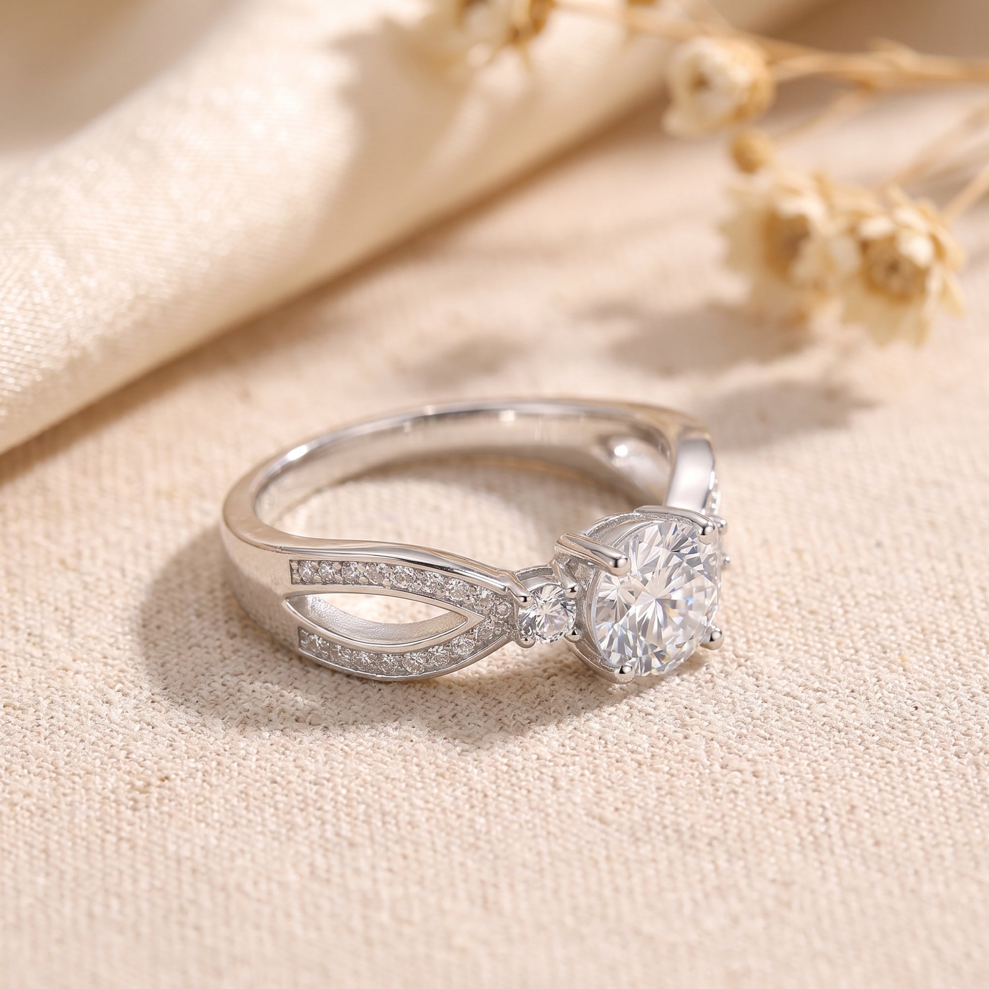 Side view of the Noeline sterling silver promise ring showing the vintage-inspired pavé bypass shank and round stone.