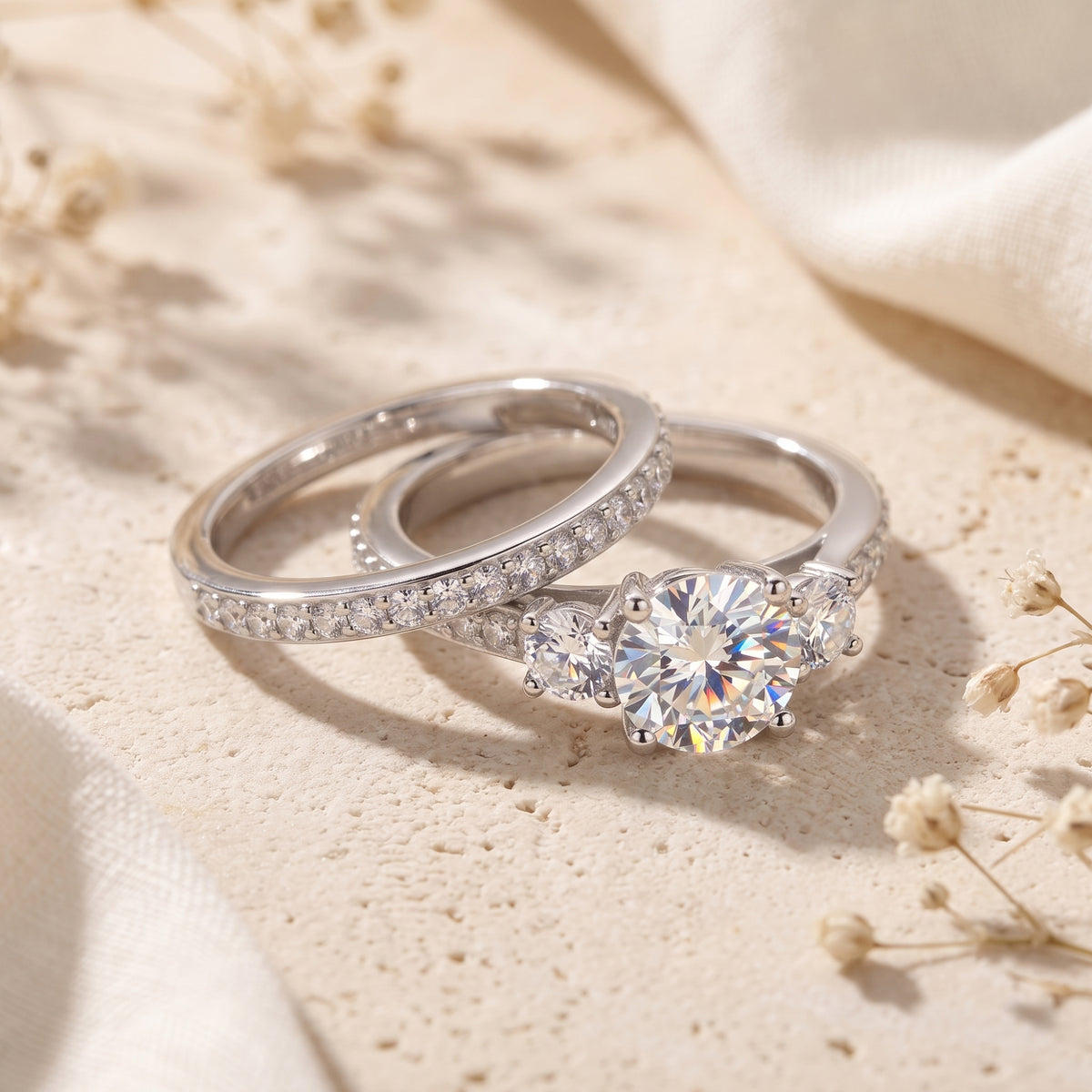 Detailed view of the Adalicia sterling silver three-stone ring and matching eternity band.