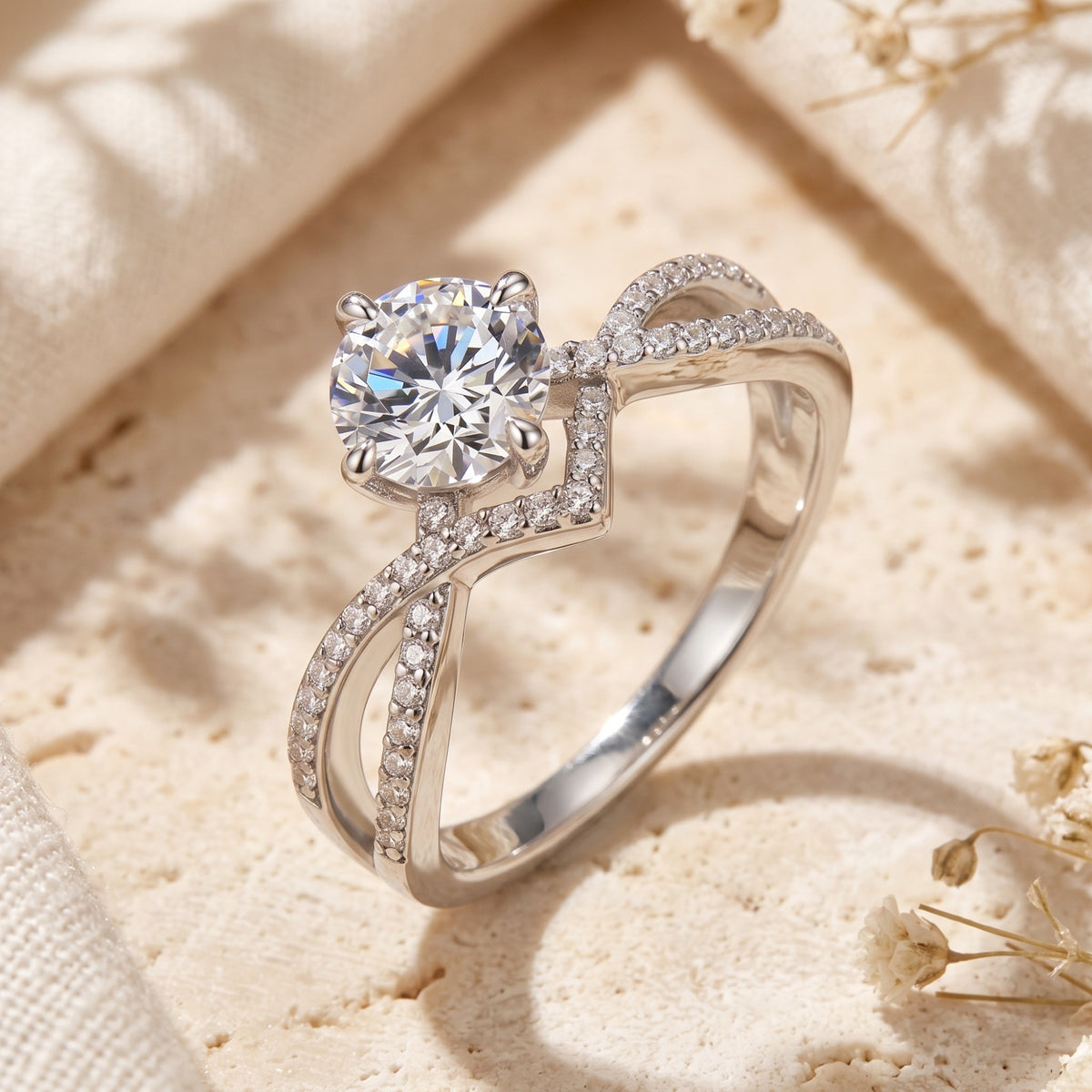 Side-angled view of the silver solitaire ring highlighting the prong-set round stone and pave chevron cradle.