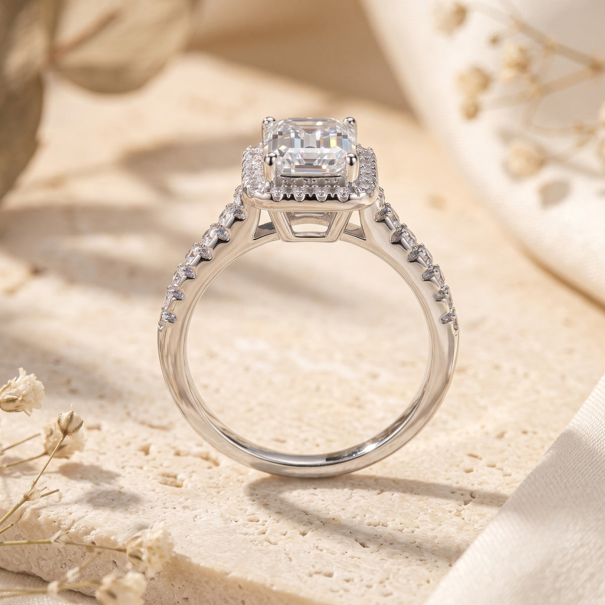 Rear view of an emerald-cut halo ring showing its open under-gallery and pavé-set shoulders.