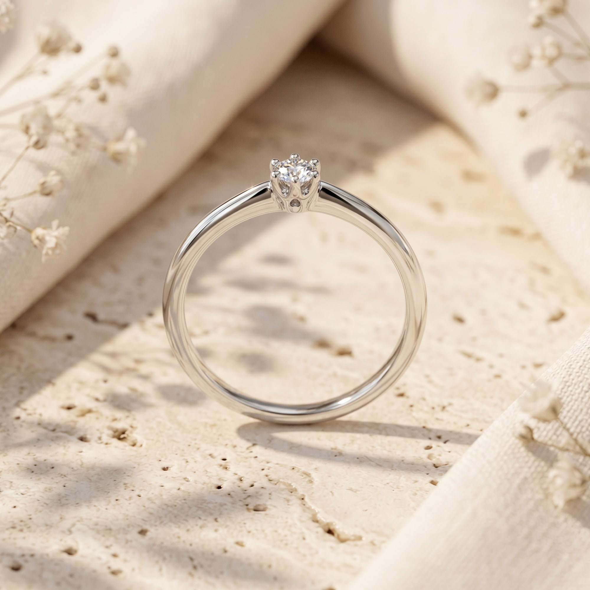 Profile view of silver moissanite ring showing the 6-prong setting.