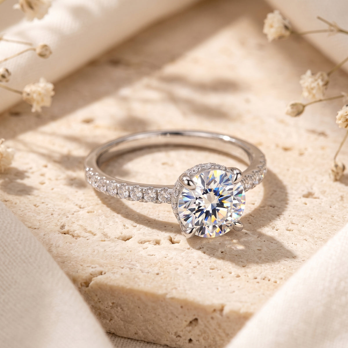 Top view of the Elorina sterling silver ring featuring a round-cut simulated diamond and pave-set band on stone.