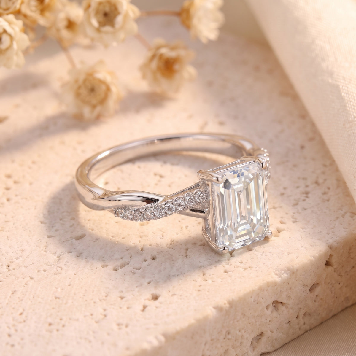 Close-up of the Cecily silver promise ring showing the emerald cut CZ and intricate twisted pavé band.