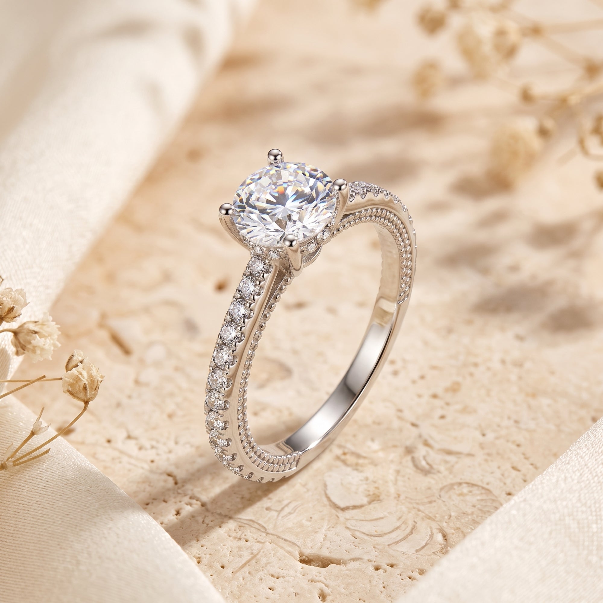 Detailed view of the Calliandra ring's four-prong basket setting and round-cut simulated diamond in silver.