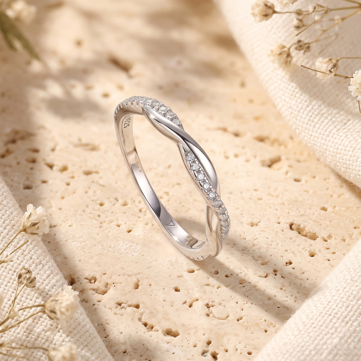 Macro view of the Veronelle sterling silver ring's twisted band design and shimmering pavé stones.