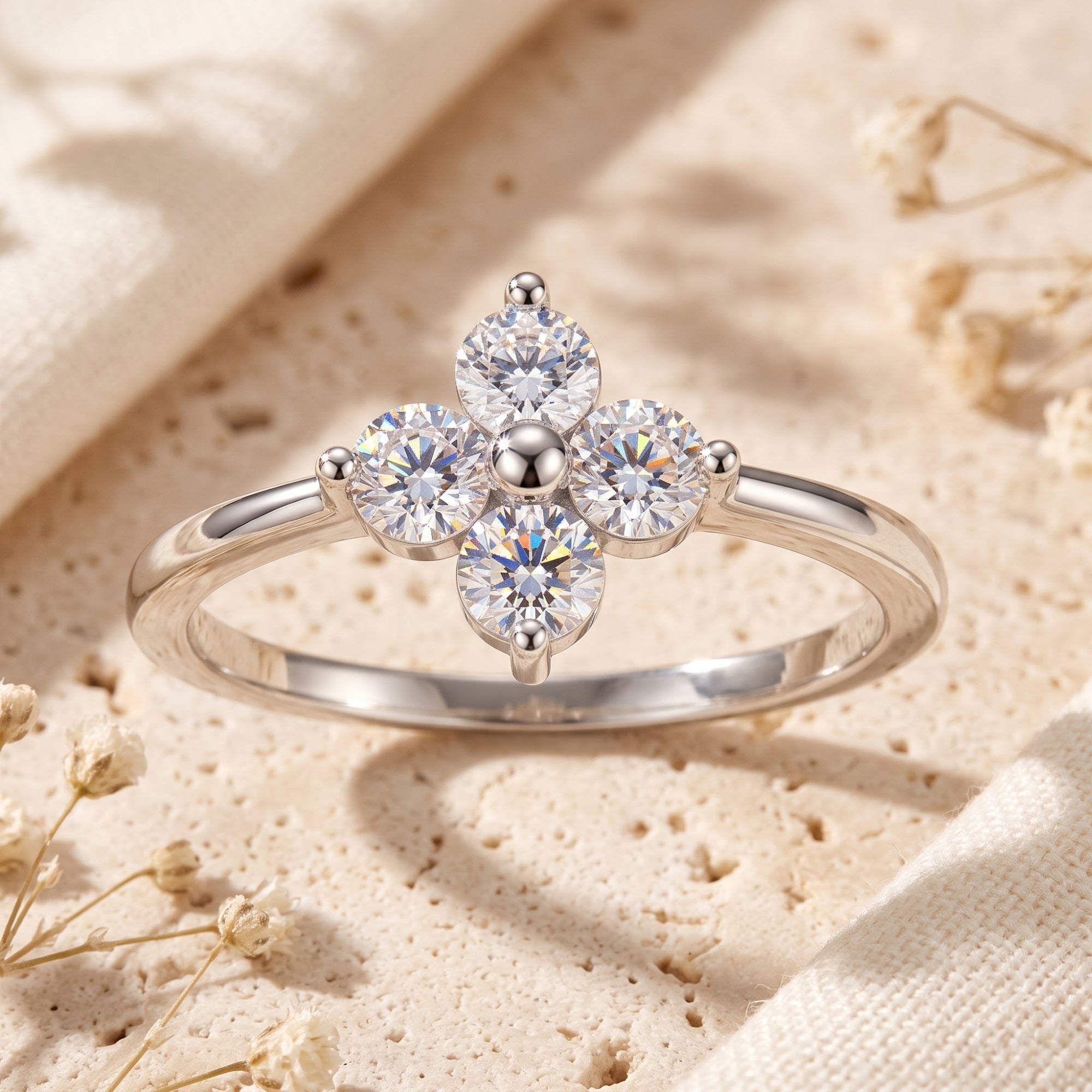 Macro view of the silver Fleurienne ring showing four round-cut cubic zirconia in a clover cluster.