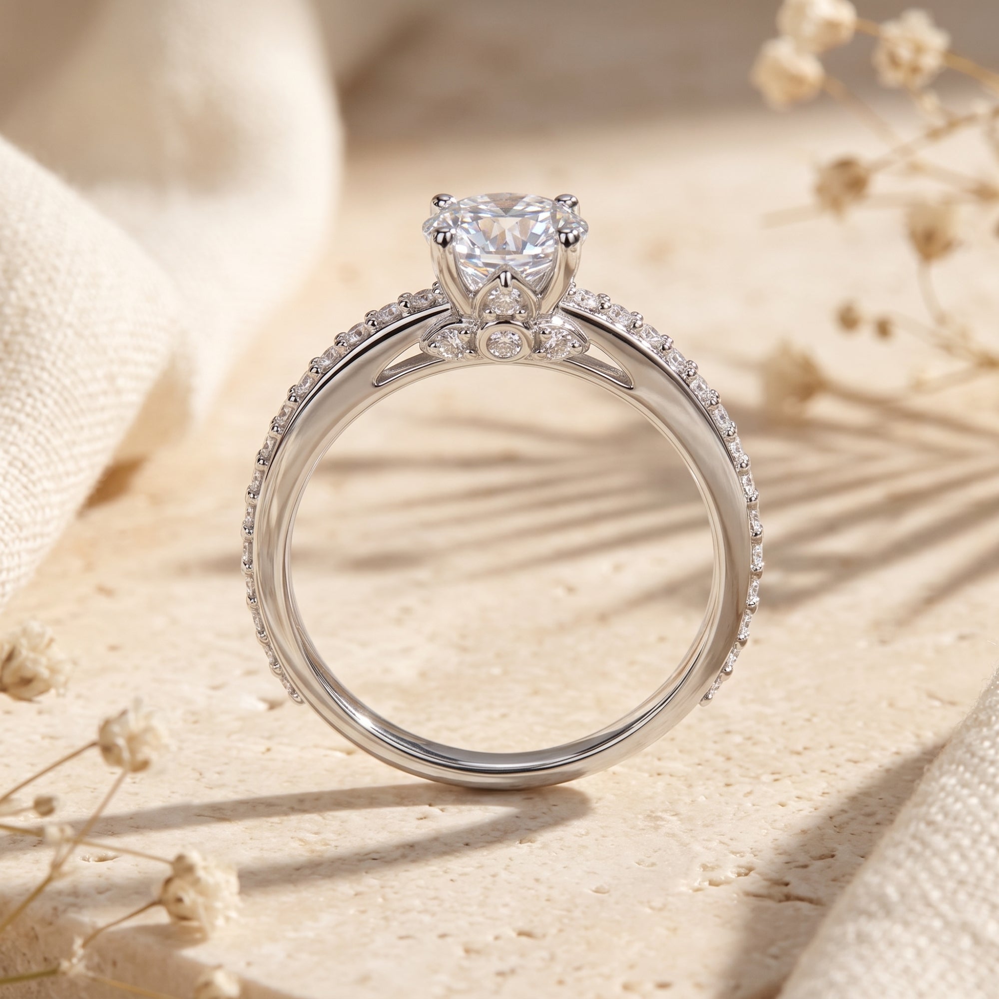 Side view of the Josephine sterling silver ring highlighting the round-cut stone and pavé setting.