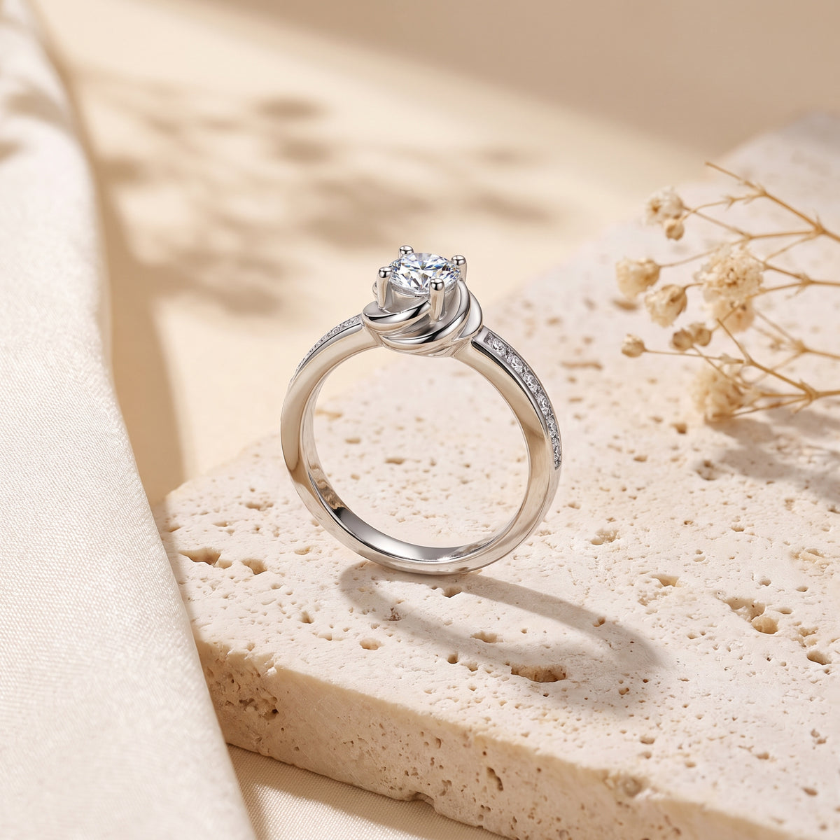 Side profile of the silver bypass swirl ring with a round-cut simulated diamond on a textured stone base.