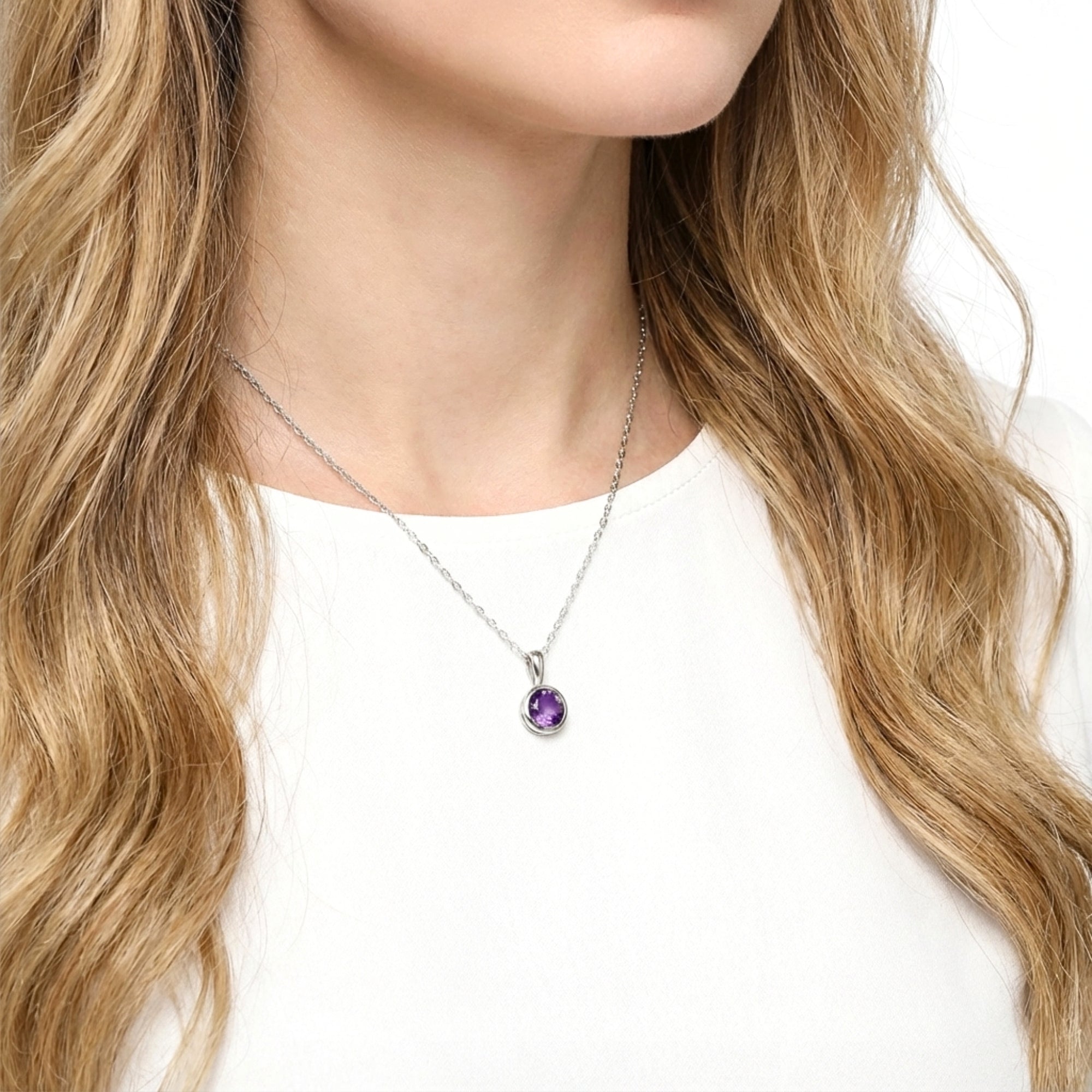 Model wearing the round cut deep royal purple simulated amethyst solitaire necklace in sterling silver.