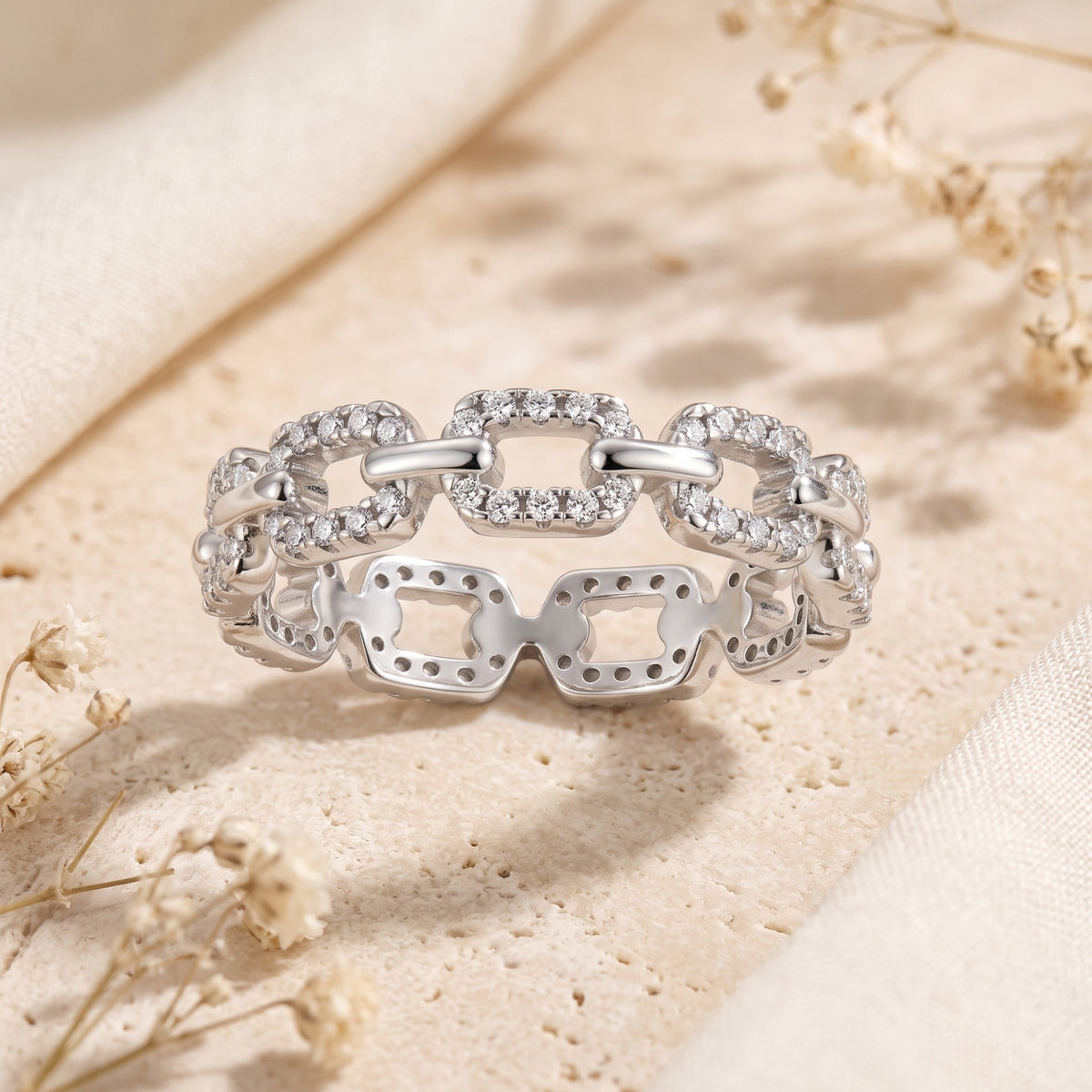 Macro view of S925 silver pavé links set with brilliant simulated diamonds.